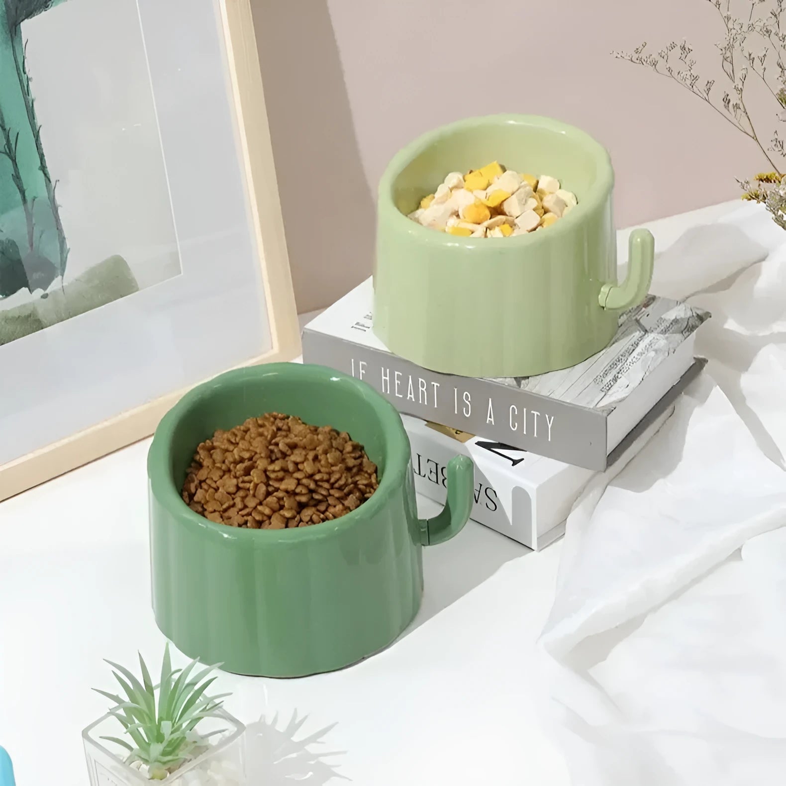Green high-stand cat bowl with cactus design and a large opening.