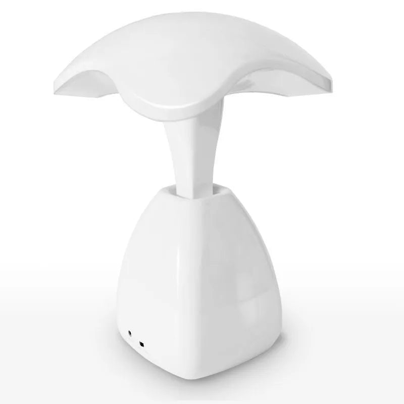White modern LED desk lamp with plastic shade and touch controls on wooden desk
