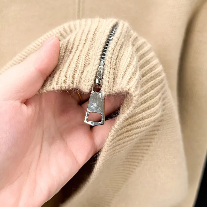 Man wearing a grey stand collar knitted cardigan with a front zipper.
