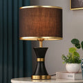 Desk lamp with iron base and fabric shade in choice of black, gold or white colours
