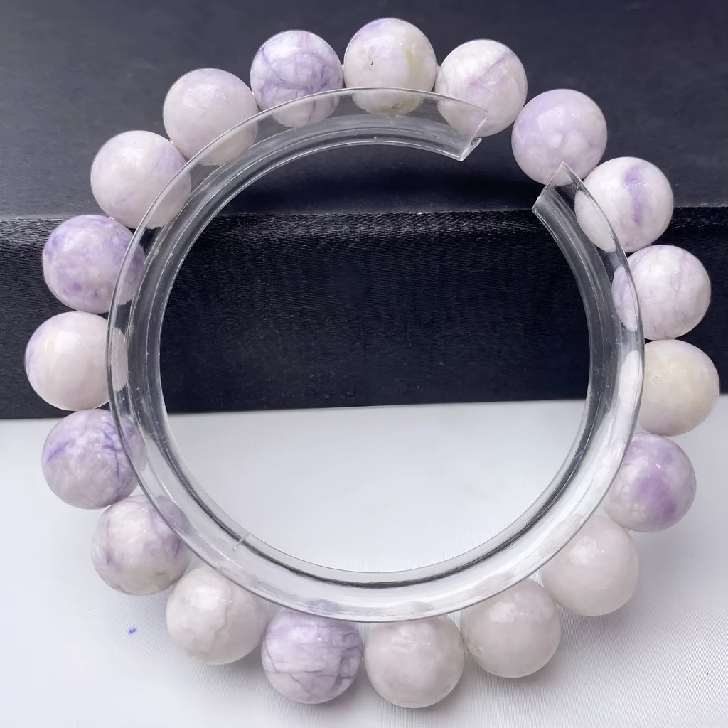 Close-up of a women's bracelet with natural purple turquoise beads on a wrist.