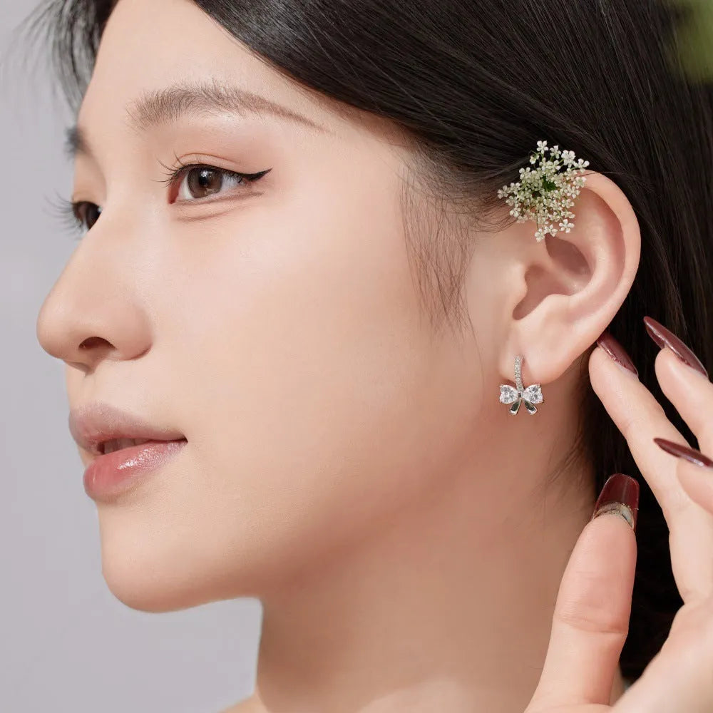 925 silver bowknot ear studs electroplated platinum finish on white background