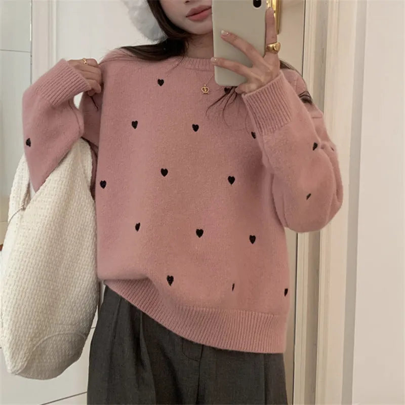 Women's loose cream embroidered acrylic pullover sweater with long sleeves, shown on a hanger.