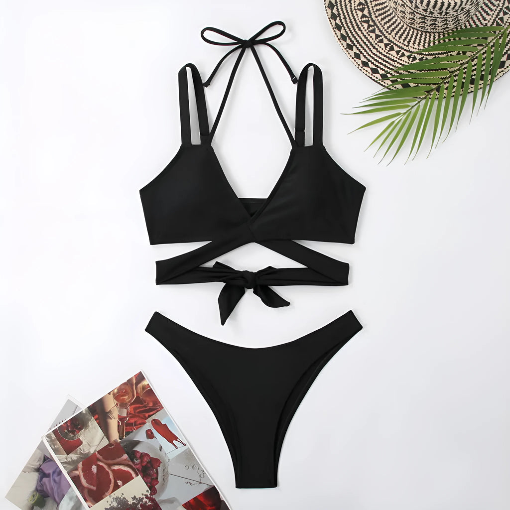 Women's solid colour strap bikini swimsuit on a hanger, shown in red.