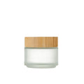 Glass cream jar with bamboo wood lid in frosted finish for facial skincare storage