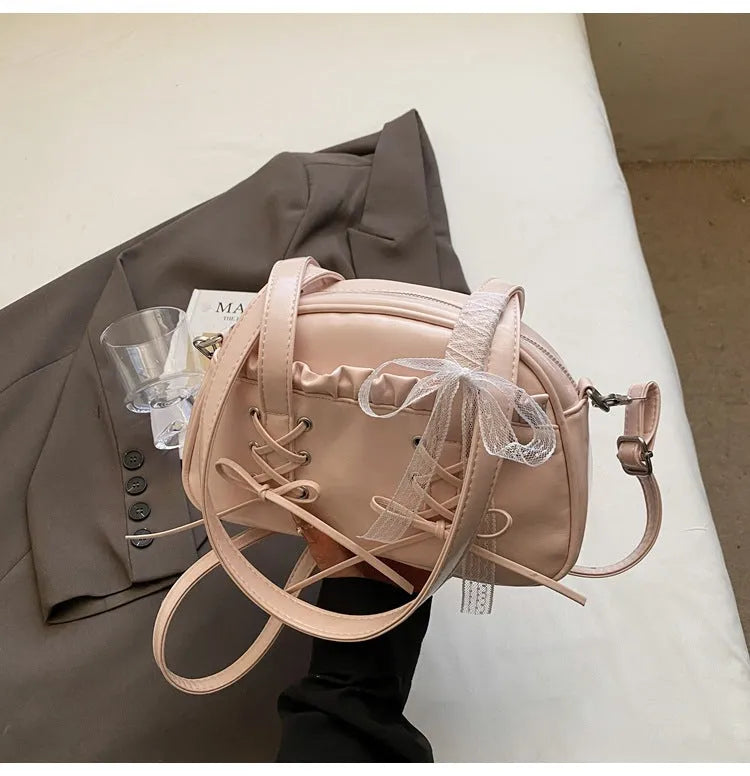 Women's bandage bow handbag in PU leather with phone compartment and sewing thread detail
