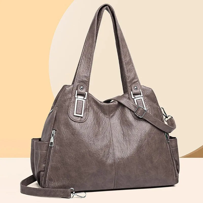 Soft PU women's tote bag in square vertical model with single shoulder strap showing internal organisational pockets