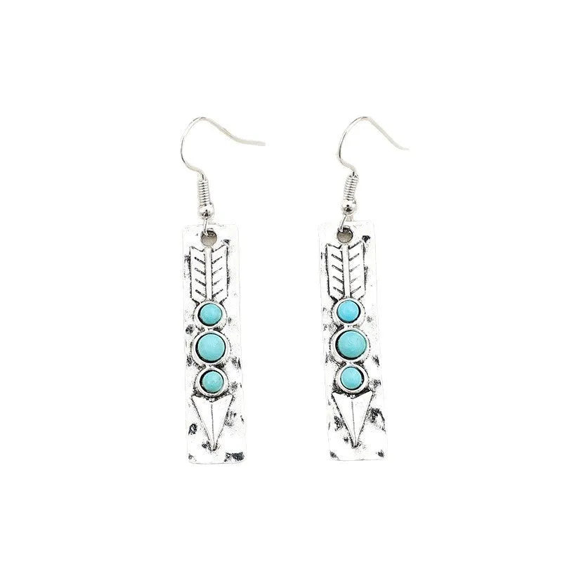 Silver geometric earrings with turquoise detail on white background