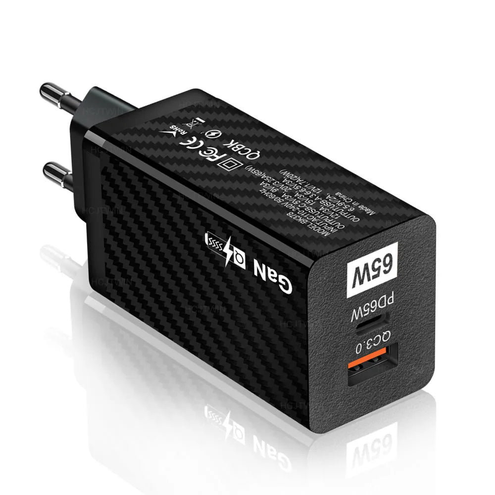 White and black 65W GaN USB-C laptop travel charger with UK, US, and EU plug options