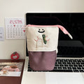 Brown collapsible cartoon design pencil case made from Oxford fabric, shown with zip open.