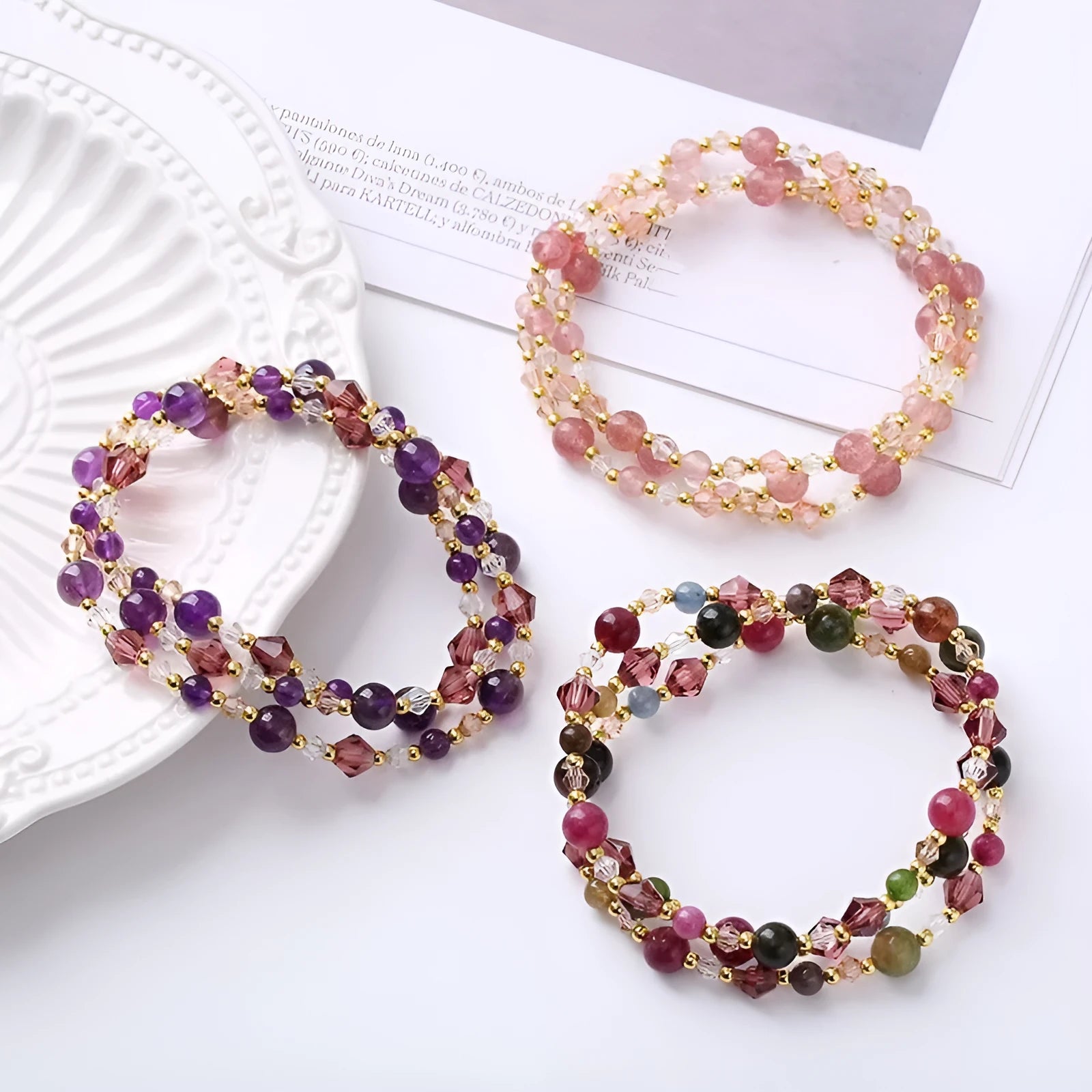 Women's three-ring crystal bracelet with tourmaline, strawberry quartz, and amethyst beads on adjustable rope.