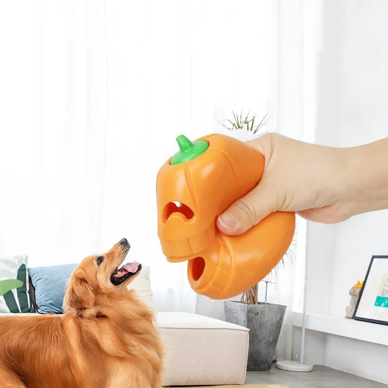 Orange Halloween pumpkin shaped durable thermoplastic rubber dog chew toy with a treat-dispensing funnel.