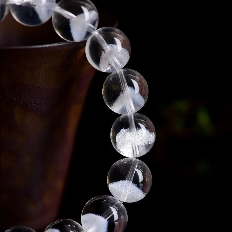 Women's white crystal ghost bracelet with a ruyi element, showing adjustable bead sizes.