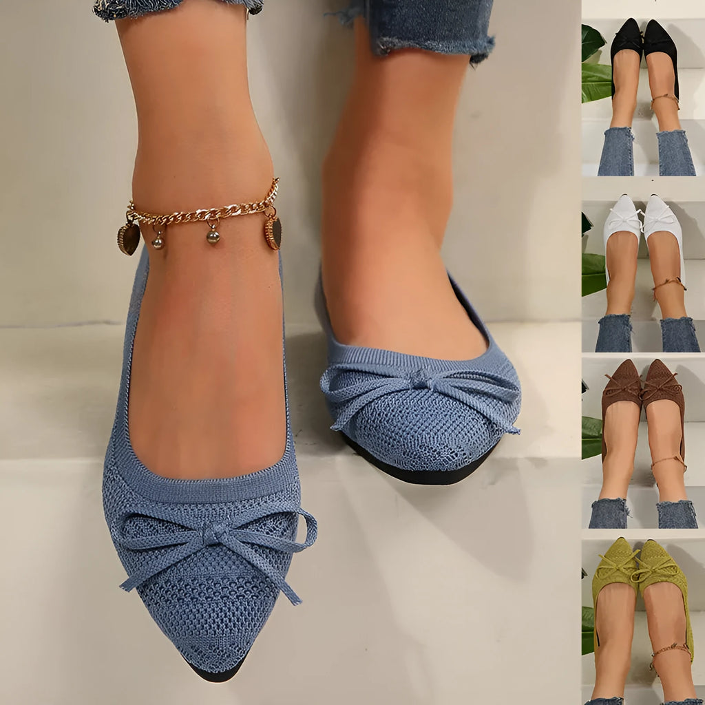Women's blue knitted flat loafers with a bow and pointed toe on a rubber sole.