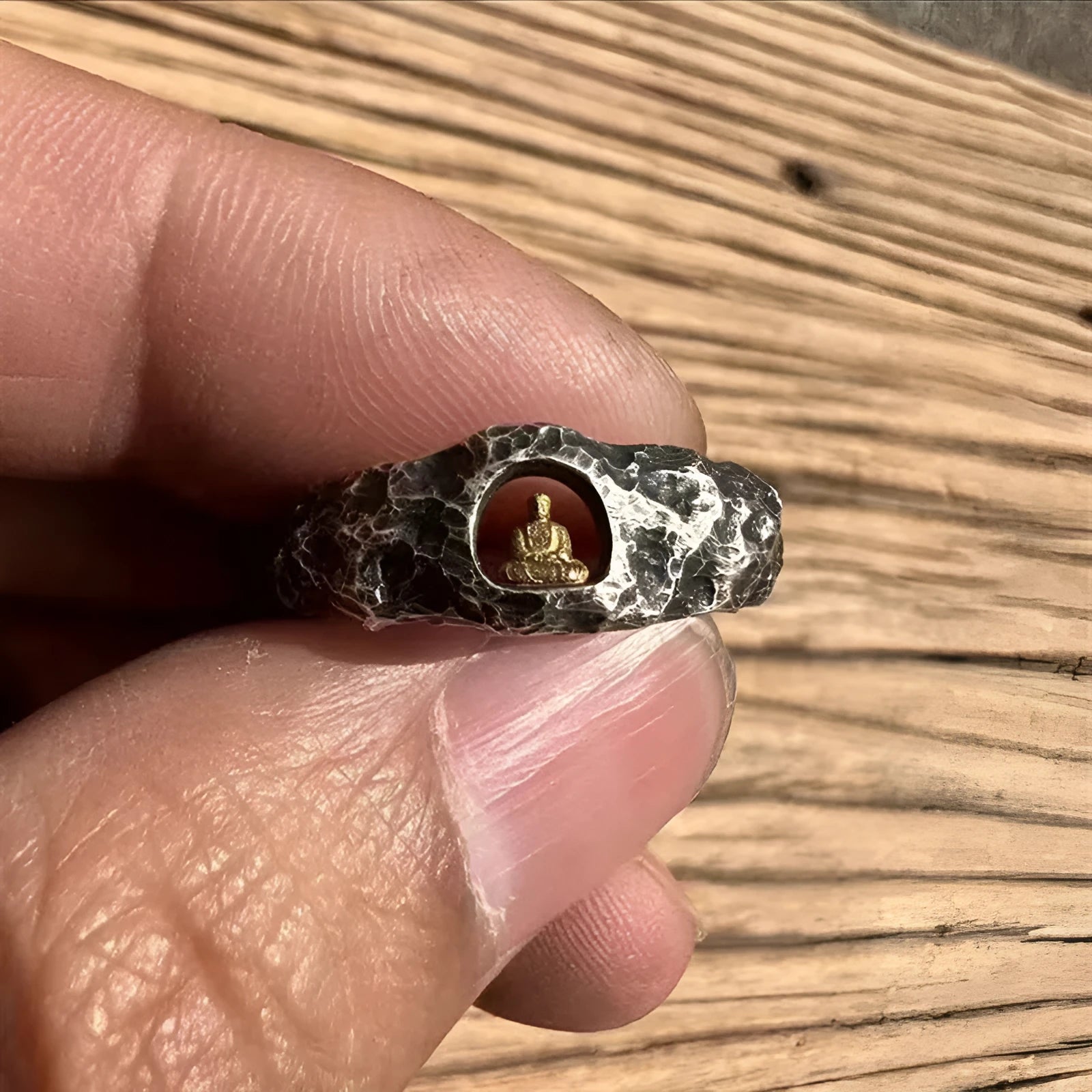 Close-up of a hand-forged copper Buddha ring with a grotto rock texture, shown in size UK 8.