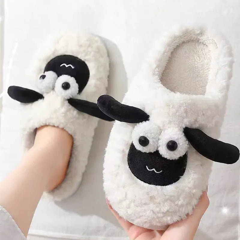 Brown lamb thermal cotton slip-on slippers with suede upper on a wooden floor.