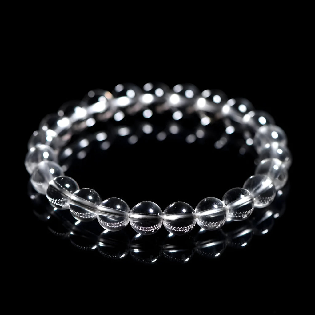 Natural old mine white crystal bracelet with round geometric beads on a wrist.