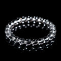 Natural old mine white crystal bracelet with round geometric beads on a wrist.