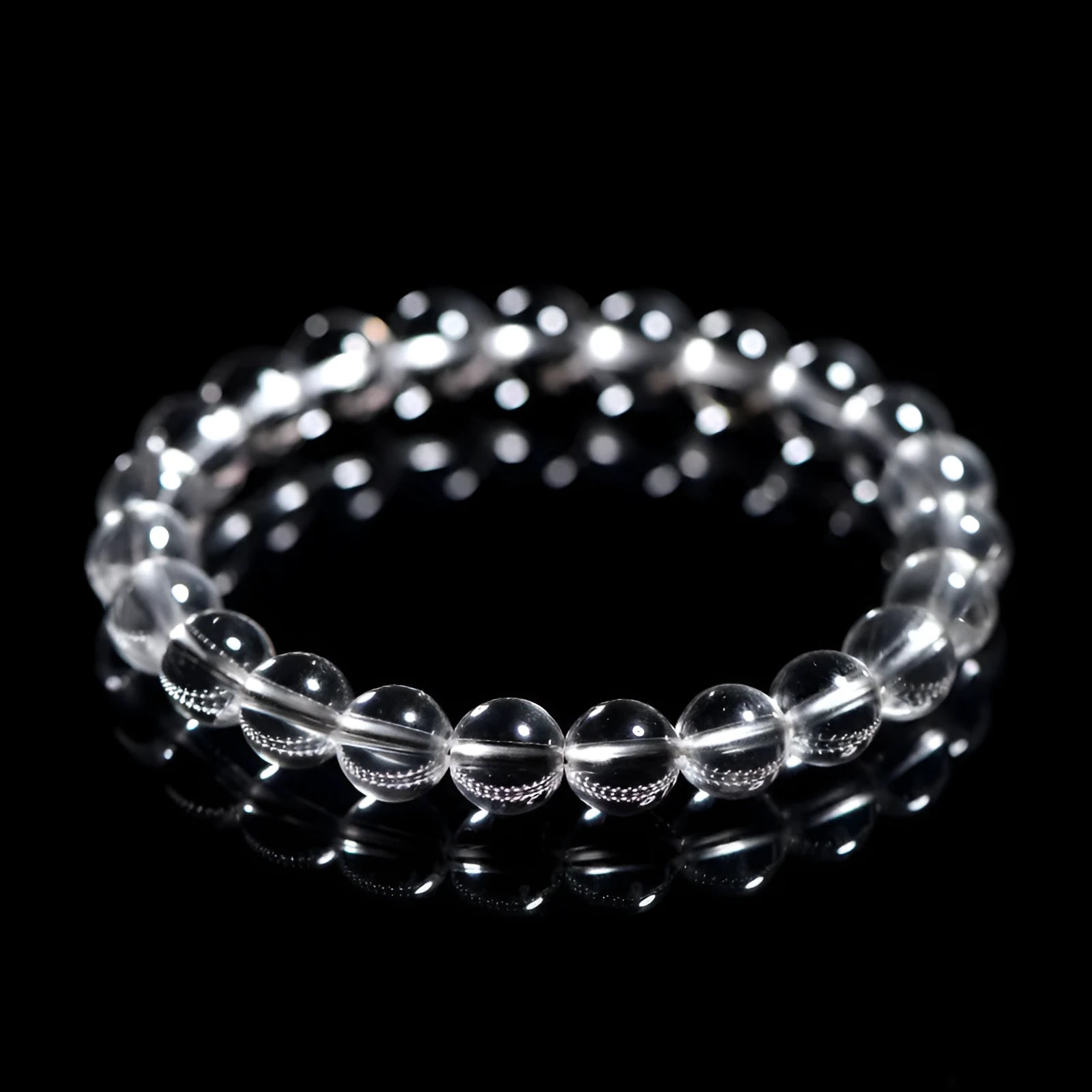 Natural old mine white crystal bracelet with round geometric beads on a wrist.