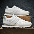 Men's black leather casual running shoes with carved wing pattern and a high heel.