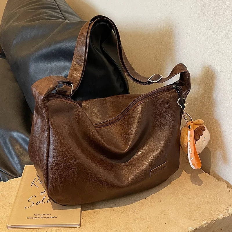 Retro PU shoulder messenger bag in dumpling shape with open pocket and sewing thread detail, black brown coffee options.