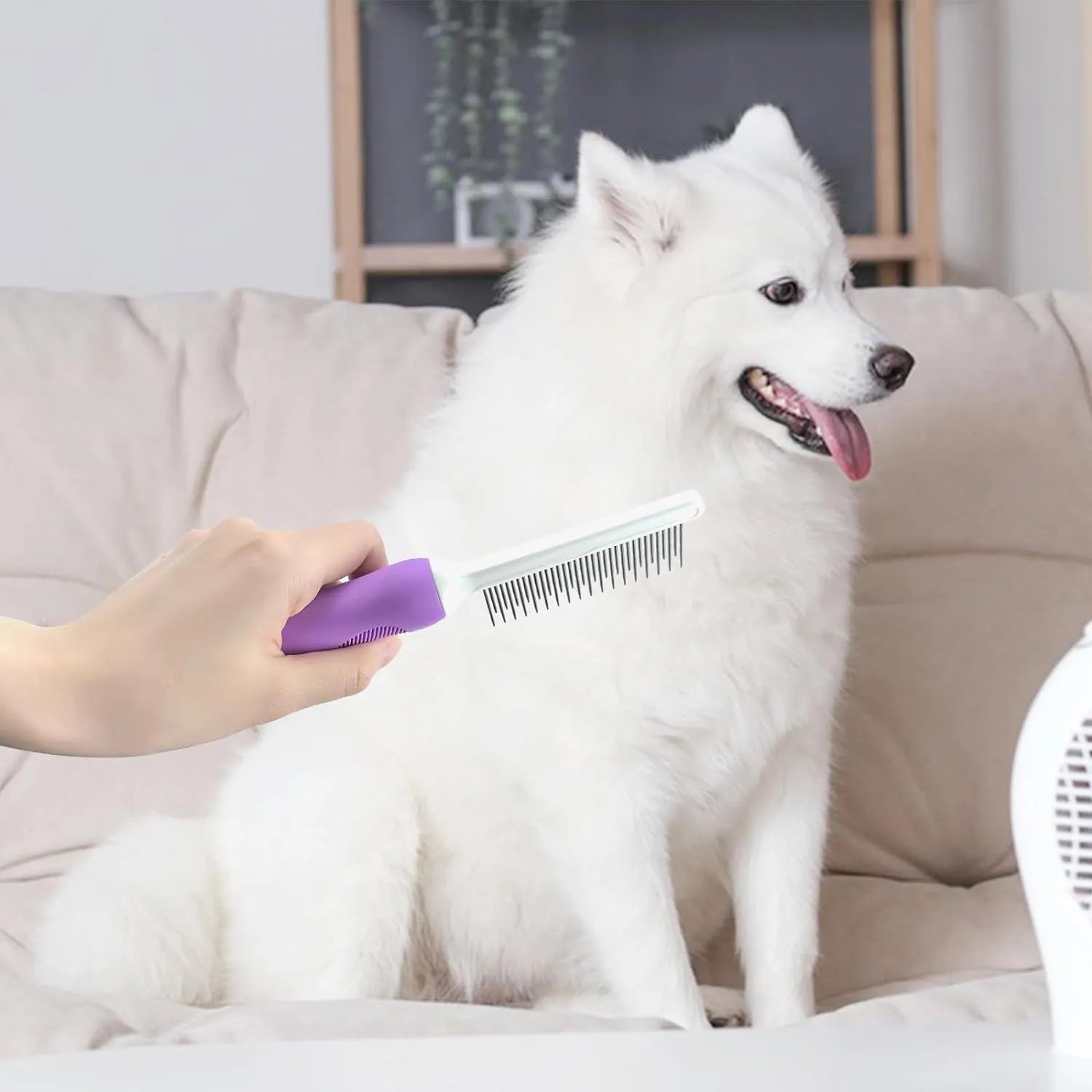 Purple pet detangling comb with stainless steel teeth and ergonomic handle on white background.