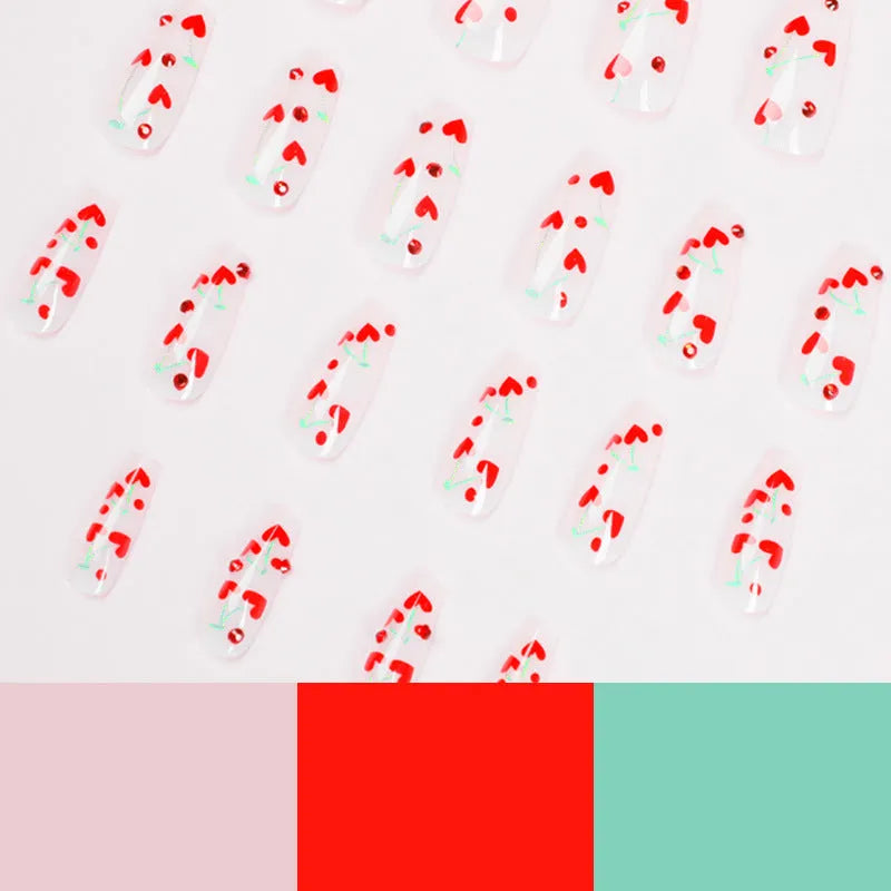 Red diamond and small cherry pattern nail art stickers on a sheet, with a tube of glue.