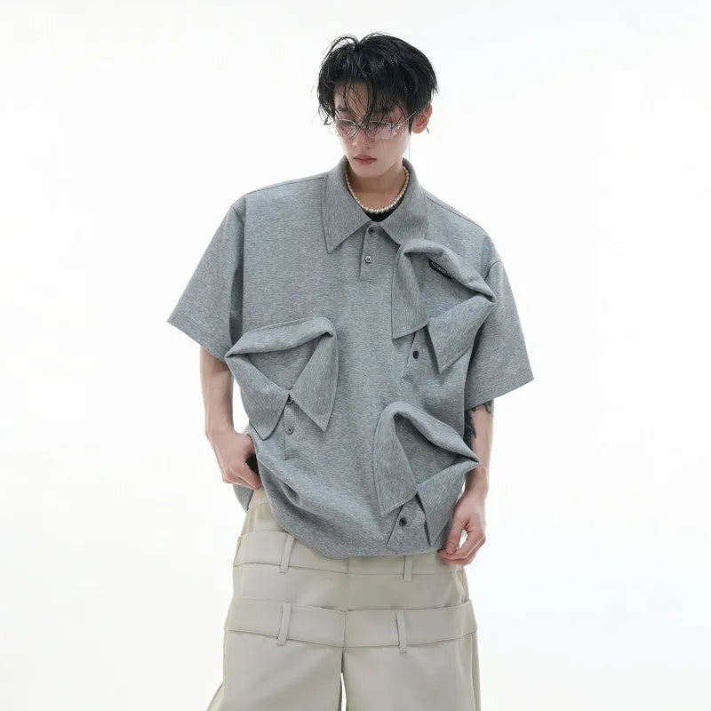 Men's black geometric print polo shirt with a deconstructed layered collar design.