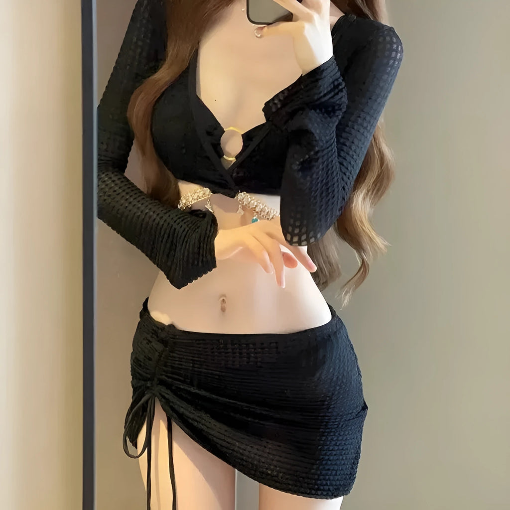 Women's black long sleeve bikini swimsuit made from polyester fabric for swimming.