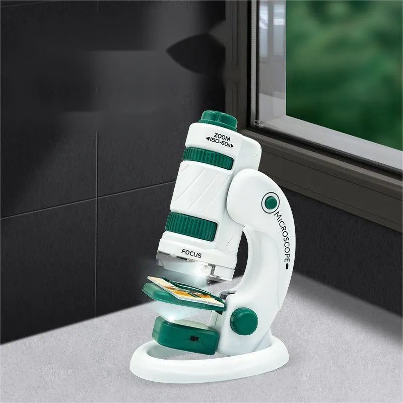 White and green portable microscope kit with specimen slides for outdoor educational use