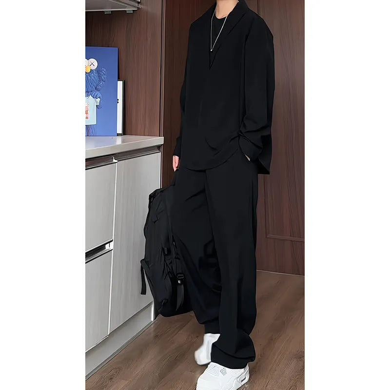 Men's black casual two-piece suit with long sleeve polo shirt and trousers on a hanger