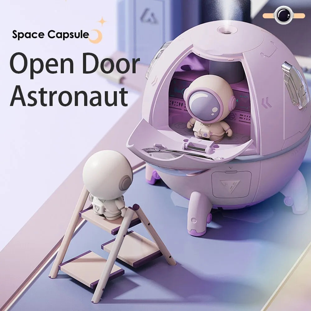 Purple astronaut space capsule USB humidifier with colourful LED lights on desktop