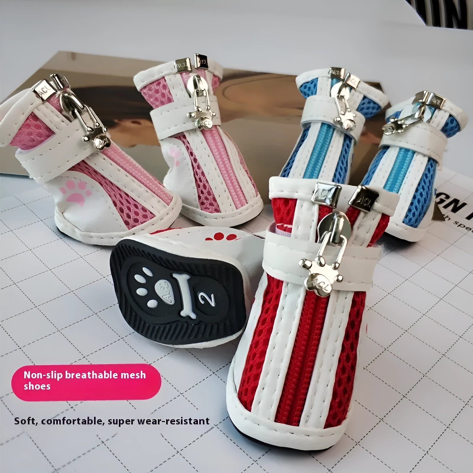 Four blue cloth dog sneakers with zipper closures arranged on a white background