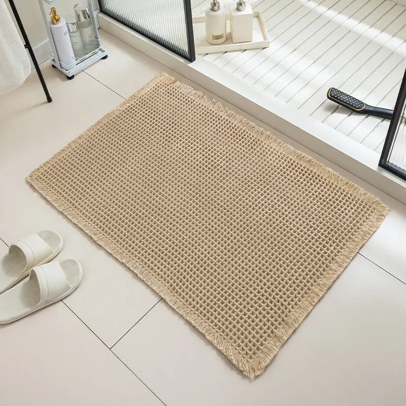 Checkered pattern non-slip absorbent bathroom floor carpet in beige colour.
