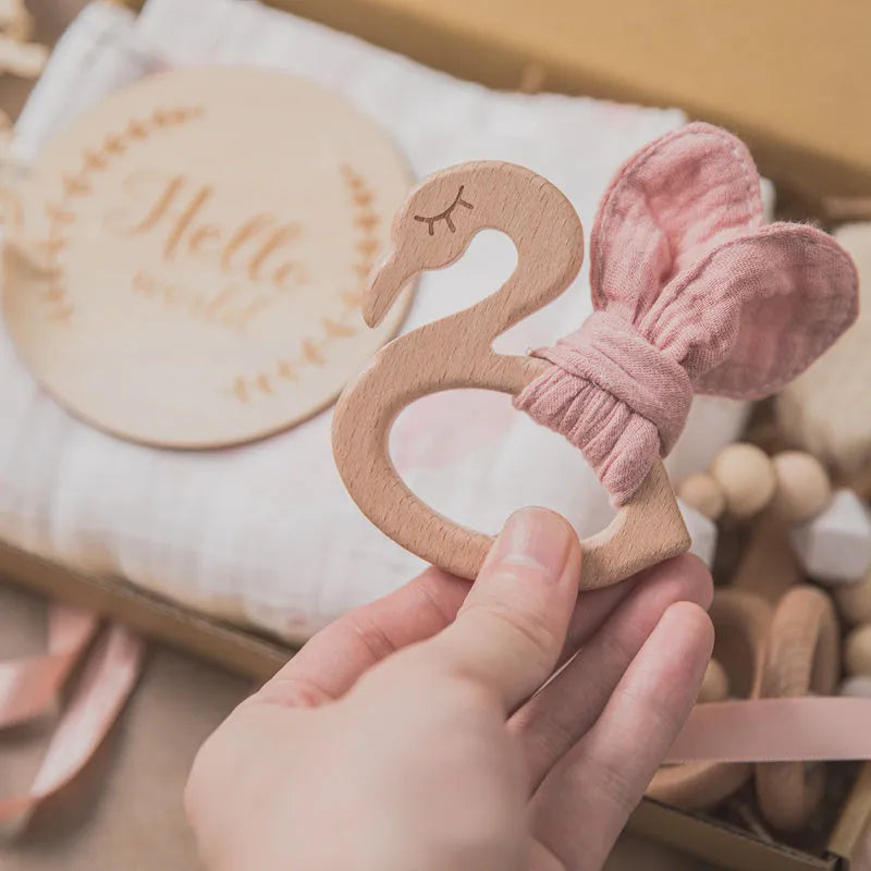 Set of six baby bath toys in peach, blue, and brown colours made from wood and chemical fibre