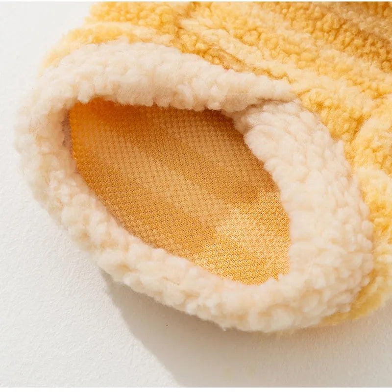 Yellow striped lambskin fleece dog clothing with bear patch and leash ring on a small dog