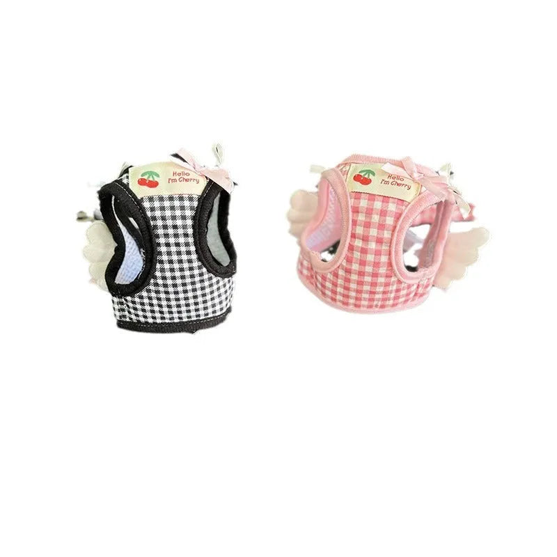 Pink and black cotton chest and back hand holding rope for a small dog on a walk.