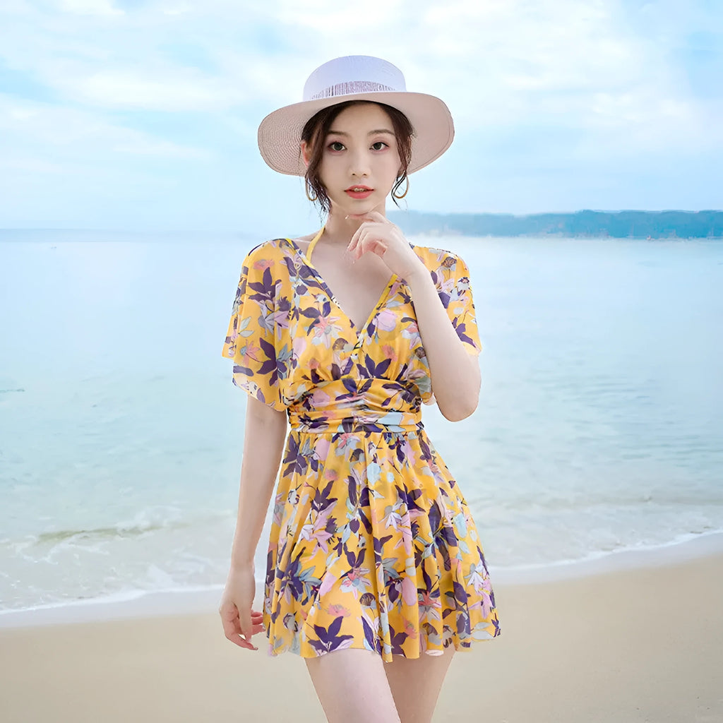 Yellow floral pattern women's one-piece swimsuit on a hanger showing front design