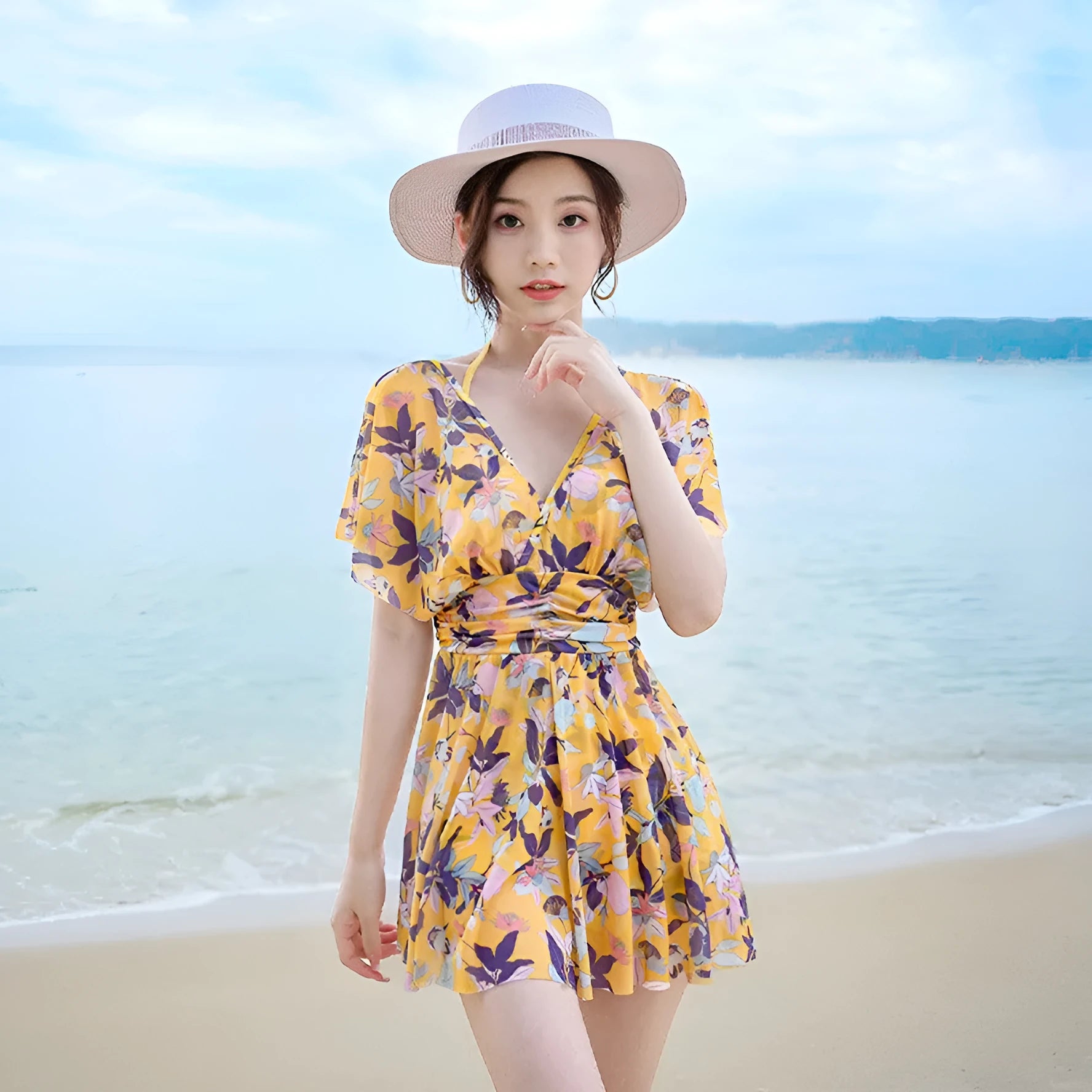 Yellow floral pattern women's one-piece swimsuit on a hanger showing front design