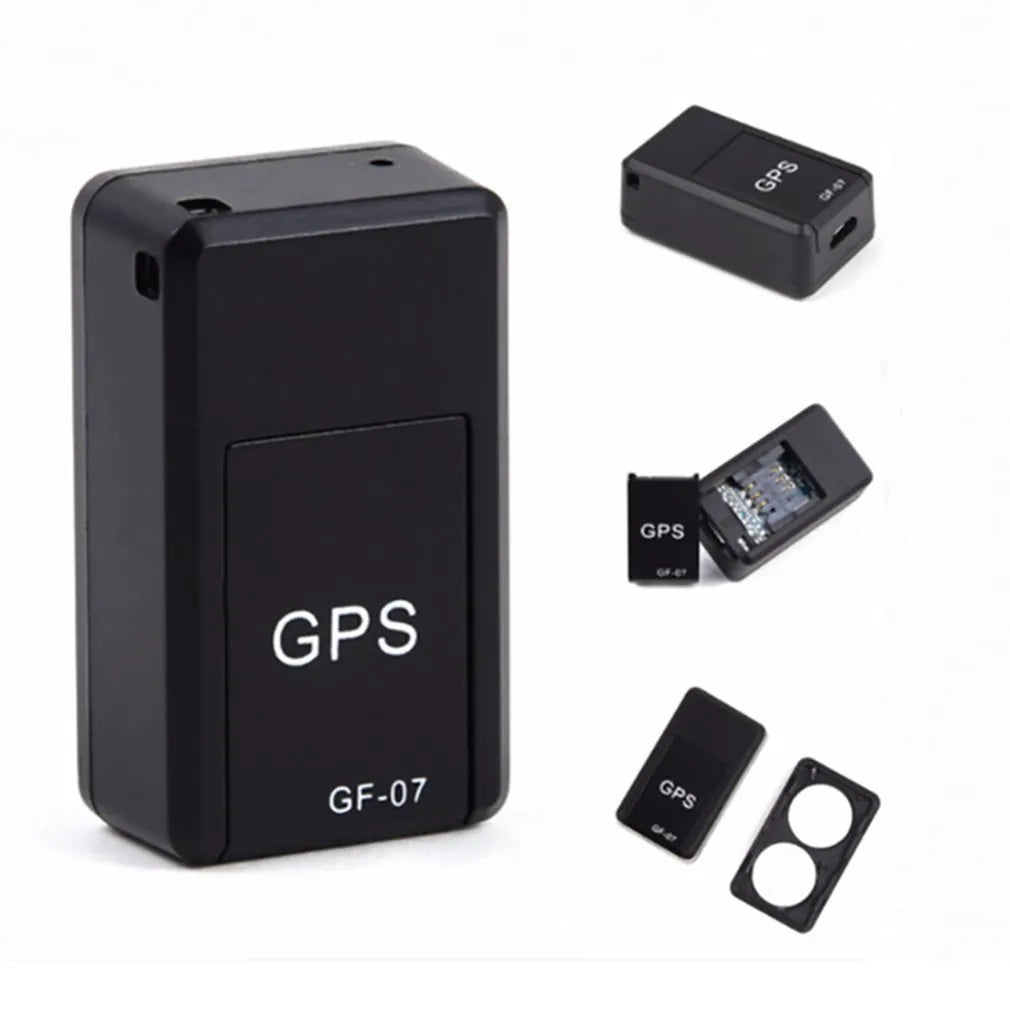Small black magnetic GPS tracker device next to a USB charging cable.