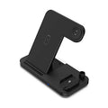 Black four-in-one wireless charging pad with QC3.0 power adapter for multiple phones.