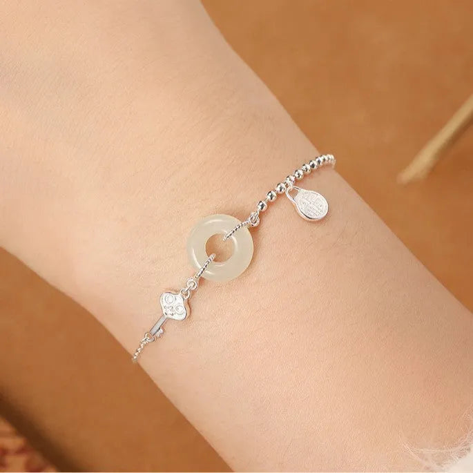Women's Hetian jade bracelet with 925 silver peace buckle charm in traditional Chinese design
