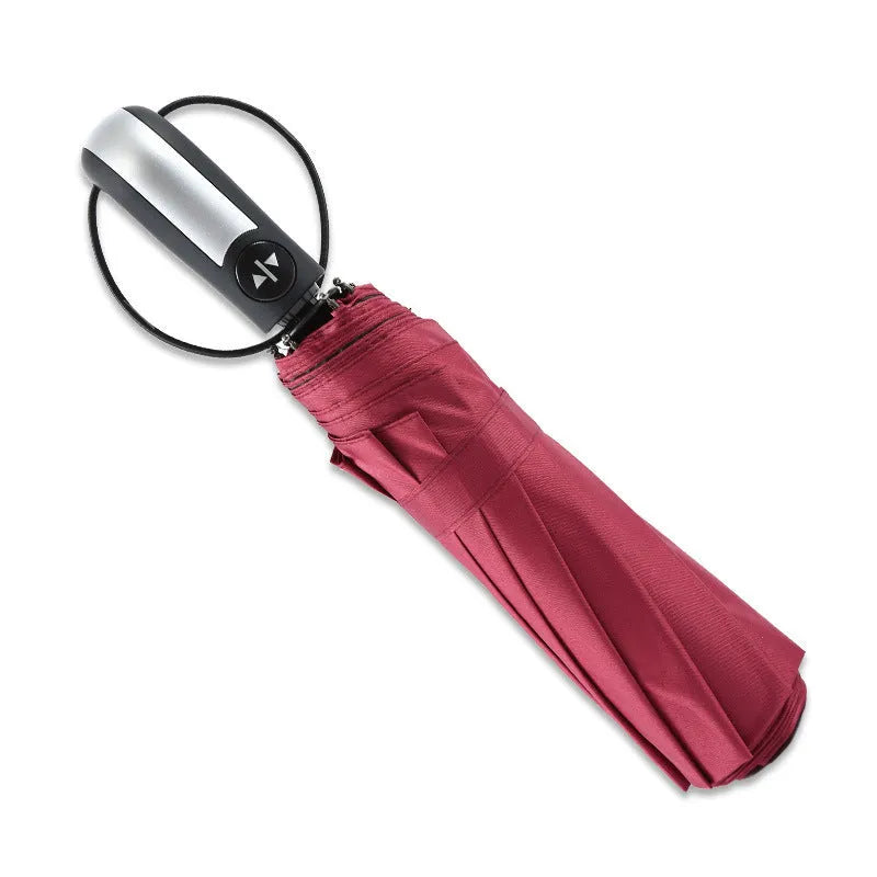 Large black automatic triple-fold umbrella with palace style canopy and rubber handle.