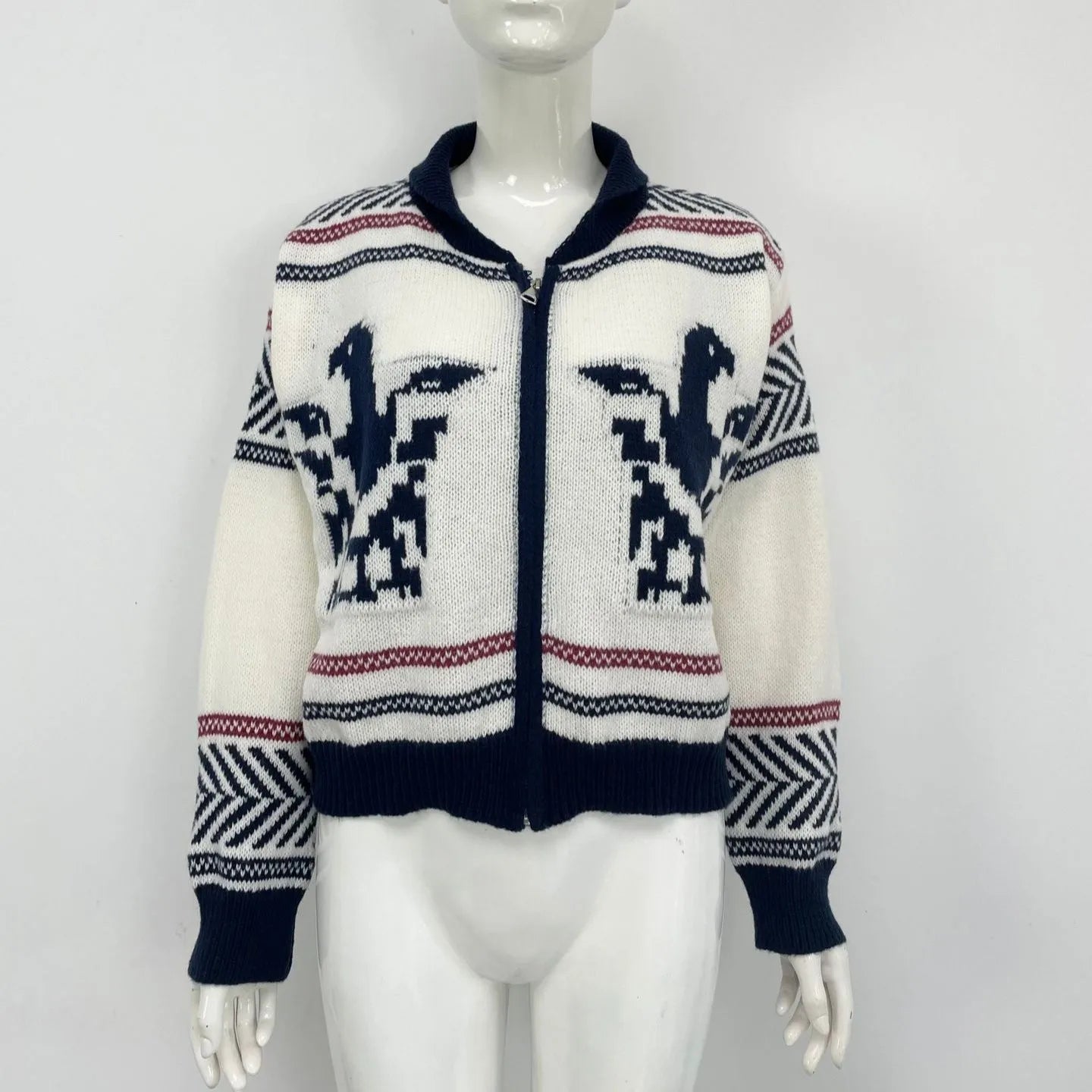 White women's zip-front cardigan with lapel collar and contrasting jacquard stripe pattern on sleeve.