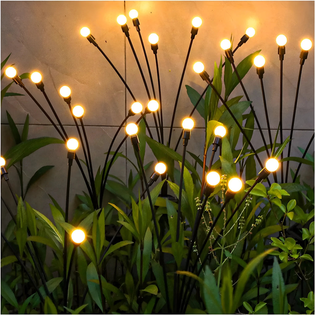 Set of solar-powered LED garden lights with ground spikes, showing firefly-style heads and solar panel.