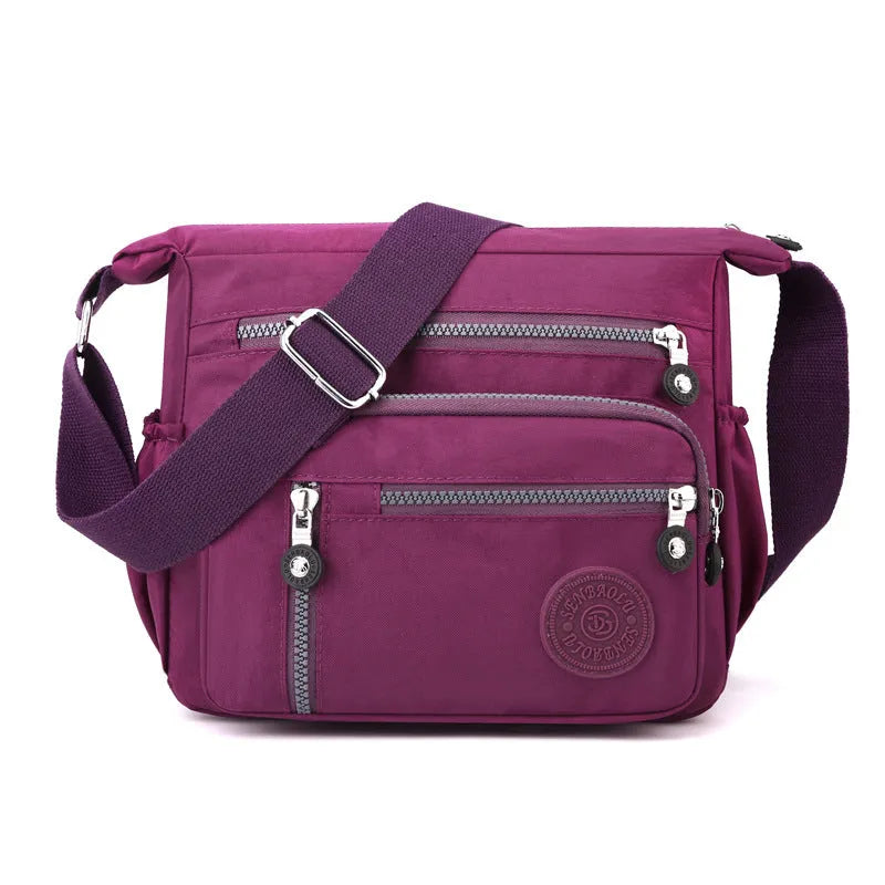 Nylon messenger shoulder bag in square vertical shape shown in light blue colour.