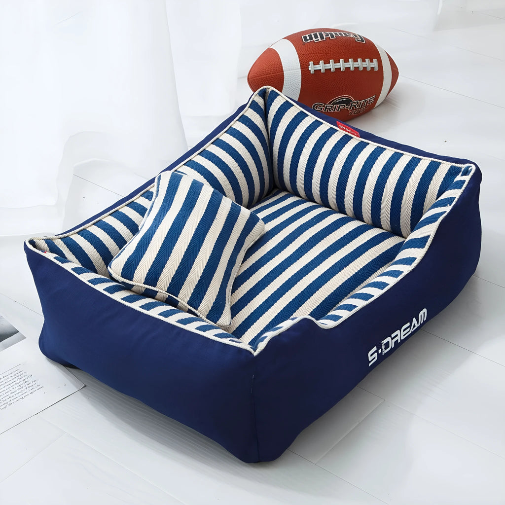 Navy stripes removable dog kennel mat and matching mini pillow set on a wooden floor
