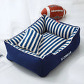 Navy stripes removable dog kennel mat and matching mini pillow set on a wooden floor