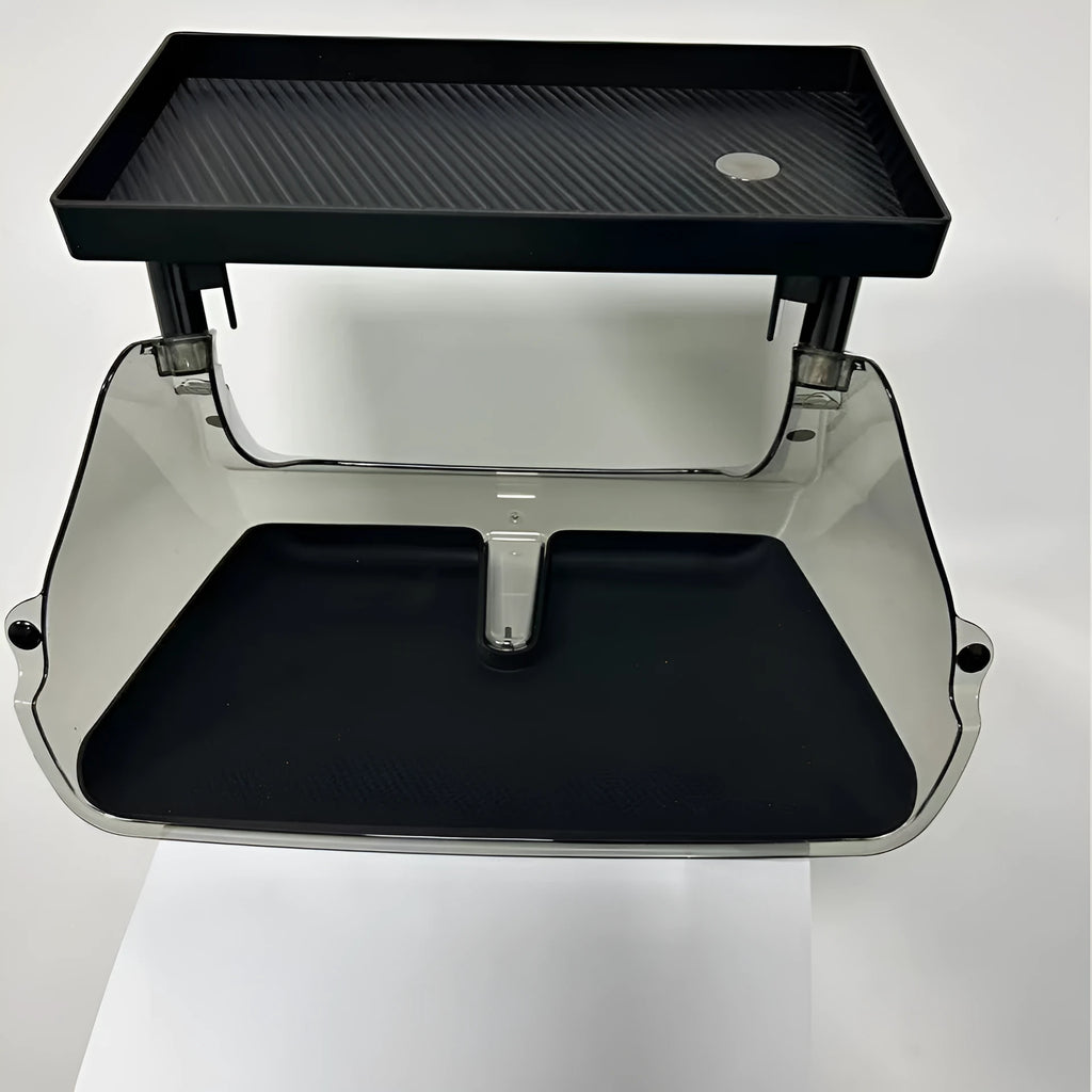 Black ABS plastic storage box fitted under the touchscreen of a Tesla Model Y interior.
