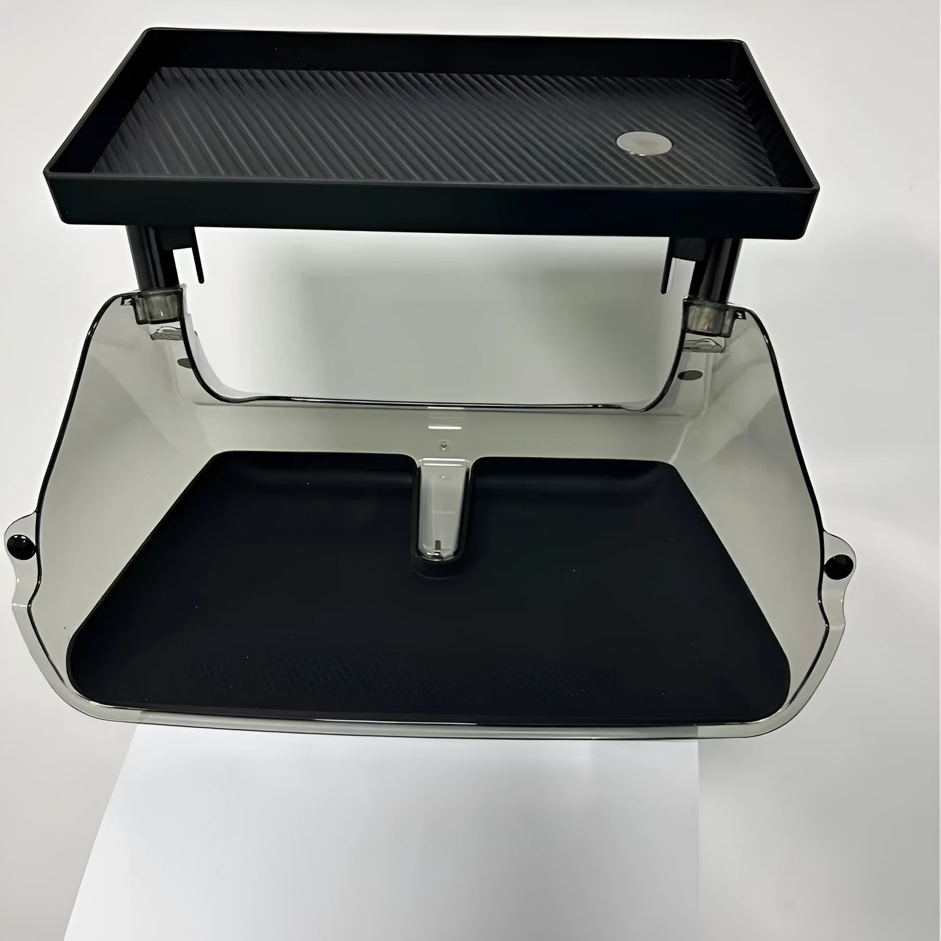 Black ABS plastic storage box fitted under the touchscreen of a Tesla Model Y interior.